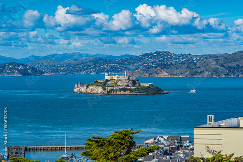 Alcatraz island view with historic site and boats on blue water under a bright sky in a coastal area