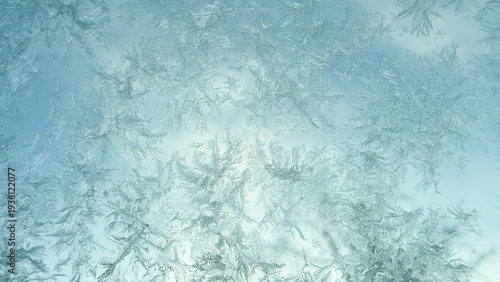 Frost crystals on glass, natural winter ice texture background