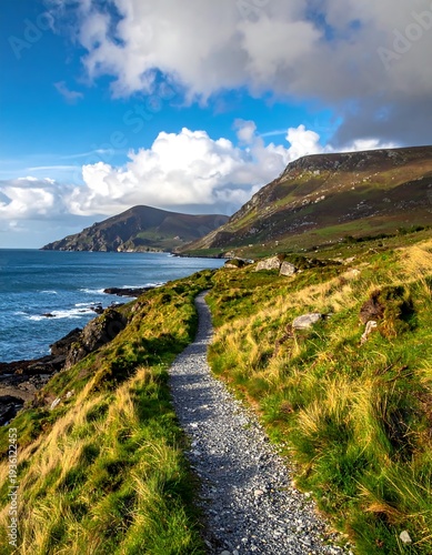 Wallpaper Mural Coastal hiking path curving along a grassy hillside, leading to rugged mountains Torontodigital.ca