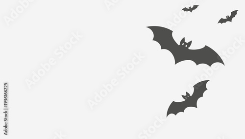 Black bats flying in the white background.