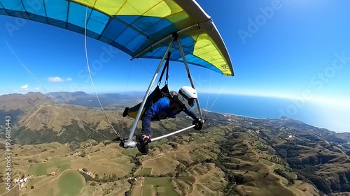 Wallpaper Mural Person flying a hang glider over a scenic mountainous landscape with vast ocean views Torontodigital.ca