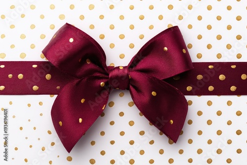 Burgundy ribbon bow on white polka dot paper