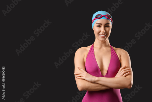 Female swimmer on dark back...