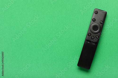 TV remote controller on gre...