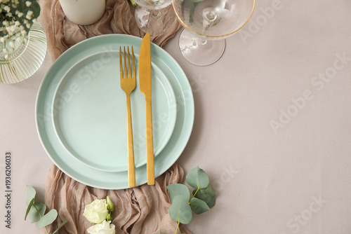 Stylish table setting for wedding with golden cutlery
