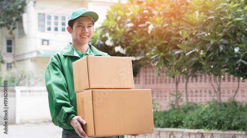 Quadro su tela A professional delivery courier in uniform handing a package to a customer at the front door of a home
