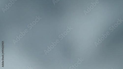 Subtle and serene abstract background with soft, flowing gradients of gray and blue