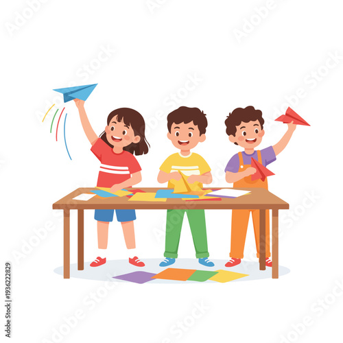 Three happy children, a girl and two boys, are busy folding paper airplanes at a table, with one girl launching her blue plane.