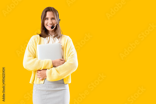 Female technical support agent with laptop on yellow background
