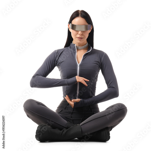 Young woman in futuristic costume with VR glasses holding something on white ...