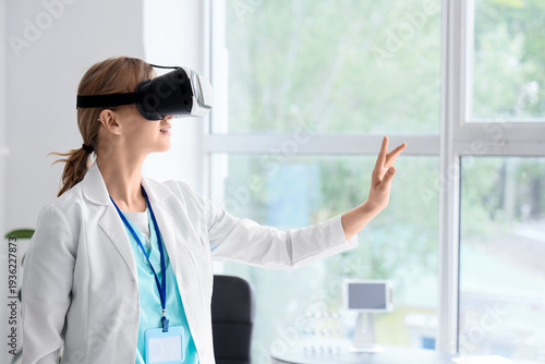 Female doctor using VR glas...