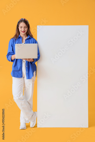 Young woman using laptop wi...