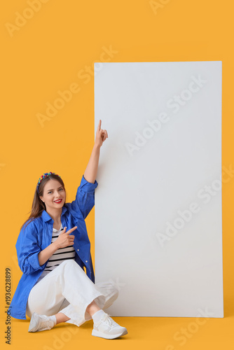 Young woman pointing at bla...