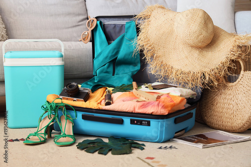 Open suitcase with beach ac...