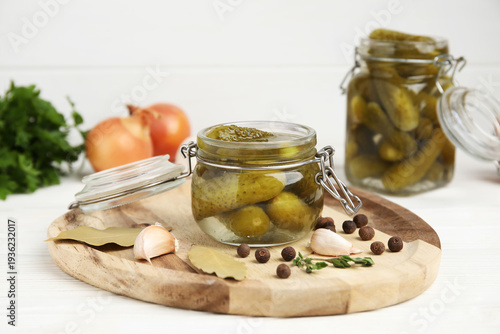 Jars with tasty pickled cuc...