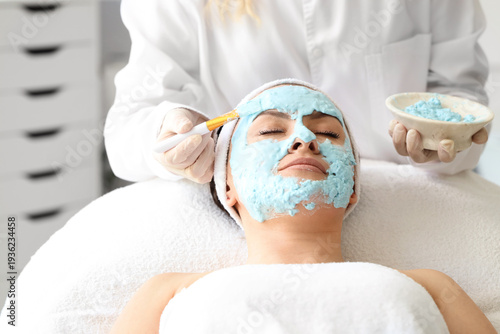 Female beautician applying ...