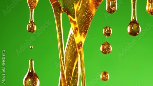 Sweet golden liquid drips and flows against a vibrant green background.