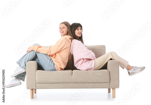 Young women sitting on sofa...