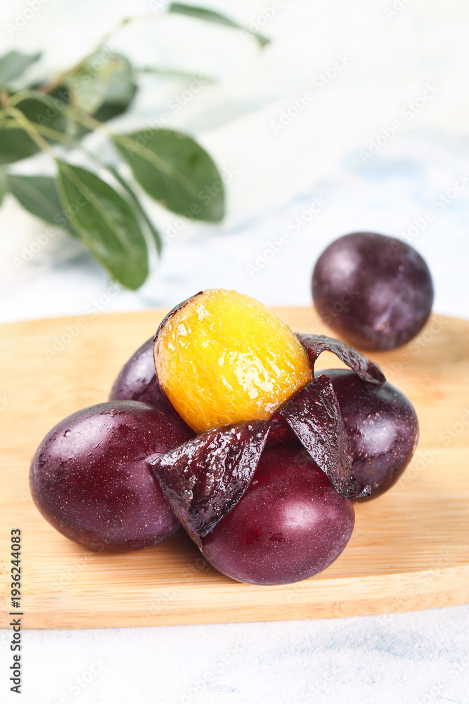 Fototapeta premium Fresh Sweet Prunes from Chile Australia Imported Dried Plums on Wooden Board