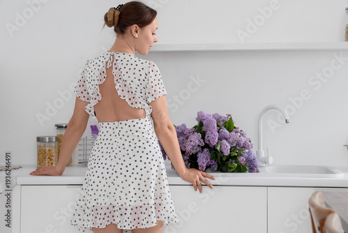 Young woman near sink with ...