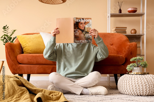 Young woman reading magazin...