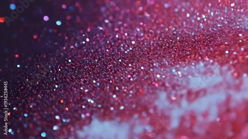 A close-up of a glittery background featuring vibrant red and blue sparkles.