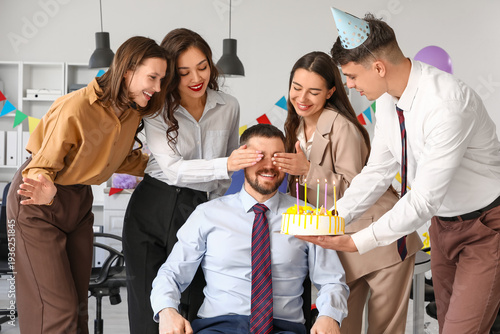 Group of young business people with cake celebrating their colleague's Birthd...