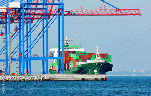 Container ship under port crane