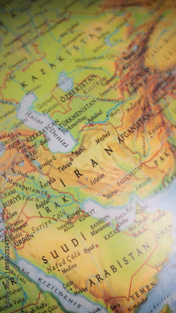 Obraz premium World map with focus on Iran. The United States and Iran are on the brink of war. Political tension or crisis. Part of the world map. Middle Eastern countries are in focus. Selective focus. 