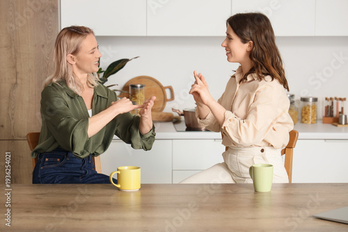 Women using sign language a...