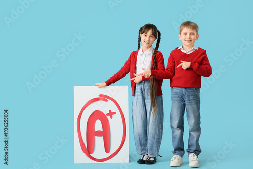 Happy pupils holding poster...