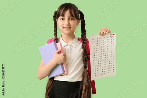Happy schoolgirl holding bo...
