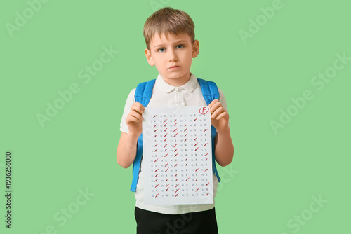 Sad schoolboy with backpack...