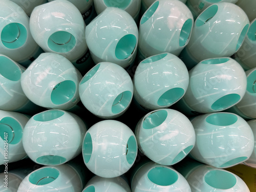 A row of green spray bottles are lined up