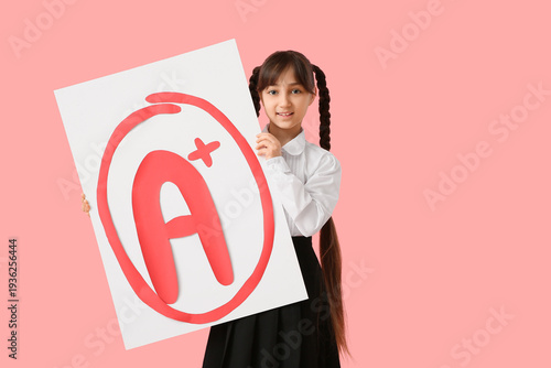 Happy schoolgirl holding po...