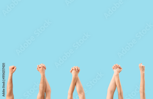 People holding hands on blu...