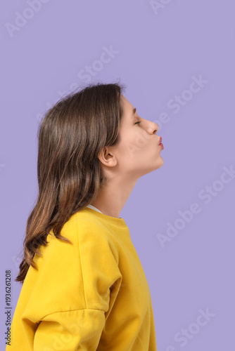 Young woman kissing on lila...