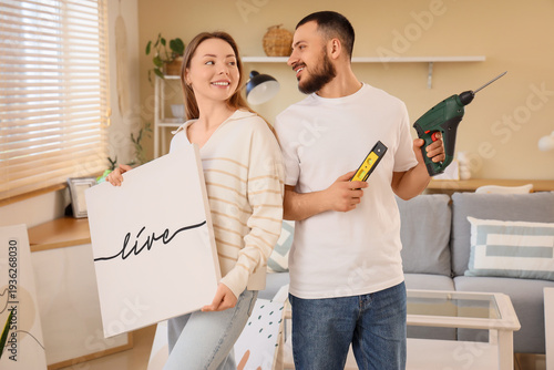 Young couple with poster an...