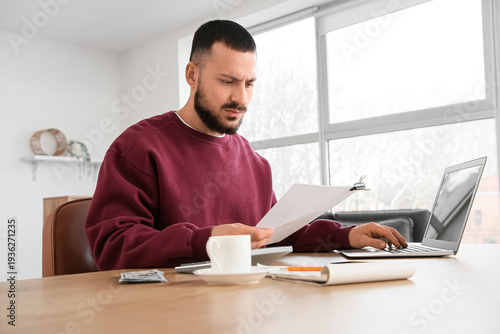 Young man with refund form ...