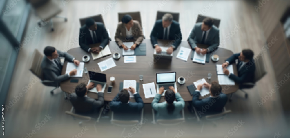Obraz premium Fully blurred corporate boardroom interior with executive meeting table.