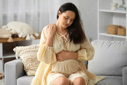 Young pregnant woman suffer...