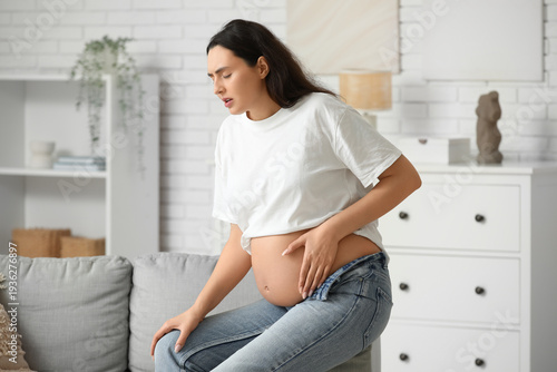 Free Download Young pregnant woman suffering from knee pain at home - GFXLoad