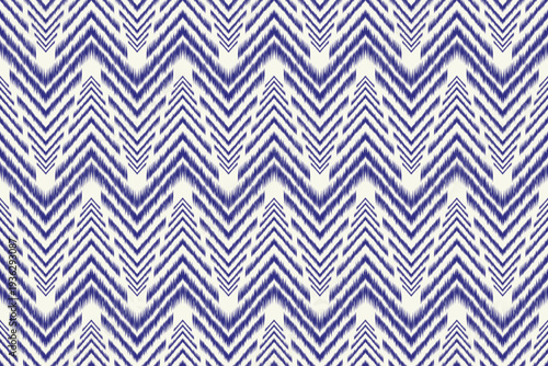 Blue and white ikat-style geometric pattern featuring repeating zigzag shapes in a seamless design. A clean, modern, and rhythmic textile-inspired background.