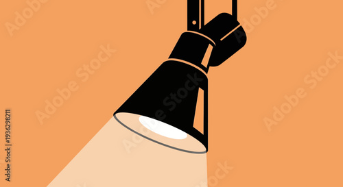 Black spotlight shining a bright light on an orange background.