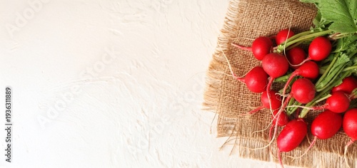 Fresh radish on light background with space for text, top view