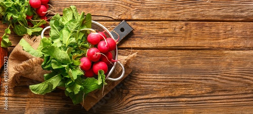 Colander of fresh radish on wooden background with space for text, top view