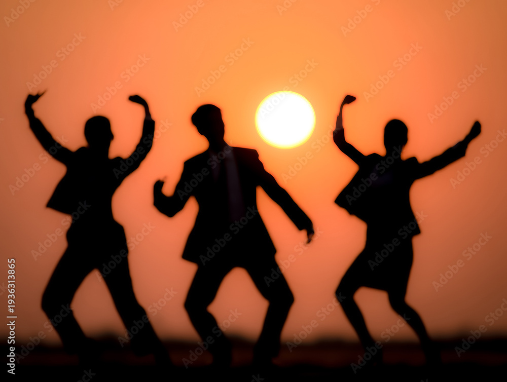 Fototapeta premium Joyful silhouettes dancing freely beneath a vivid setting sun.