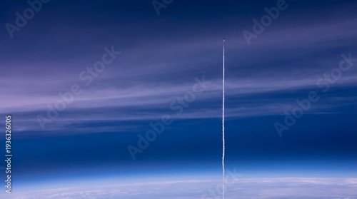 Rocket launching into space with contrail against blue sky