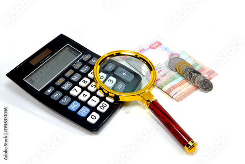 Close up of calculator, and magnifier stacked United Arab Emirates Dirham banknotes, and various denomination coins arranged together on a clean white background for financial accounting concepts.