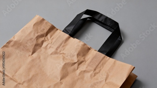 Brown paper bag with black handles